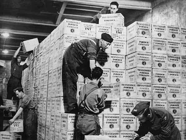 Cases of TNT gunpowder stacked in the dump 100 feet underground. Circa 1940.