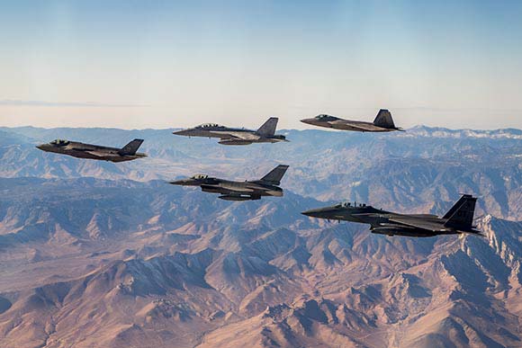 An F-35 Raptor, F-16 Fighting Falcon, F-15E Strike Eagle, F-22 Raptor and F-18 Hornet over the Sierra.