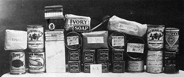 American Red Cross - Prisoners of War - This is Army food box and is sent the prisoner a week after he is sent the First Parcel. This package contains corned beef, 1lb salt pork, 1lb can slamon, 2lbs corned beef hash, 1 can pork and beans, 1lb tomatoes, 2 cans of corn, 2 cans of peas, 3lbs hard bread; 1lb butter; 1lb sugar; 1lb prunes; 1 bar of soap; 80 cigarettes; 4 pkgs of tobacco or one cut of chewing tobacco.