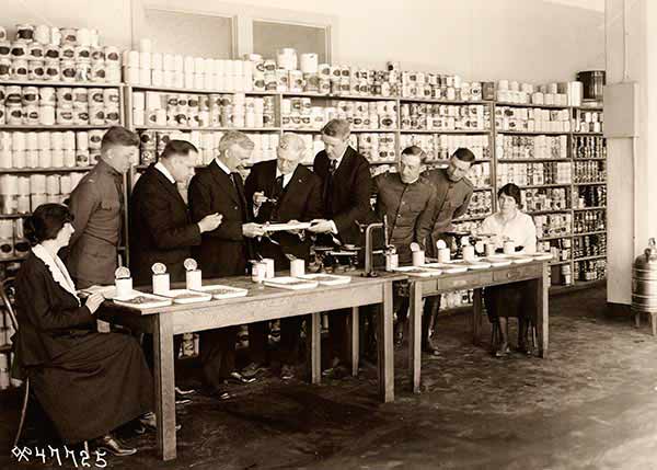 Inspecting food for U.S. Army. Examining canned peas. 30 April, 1919.