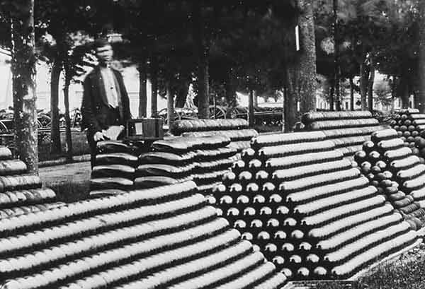 Rows of Stacked US Civil War Cannon Balls Featuring Rifled Projectiles Near the Center or the Image.