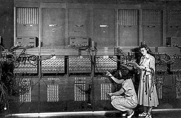 Two women wiring ENIAC to run a program.